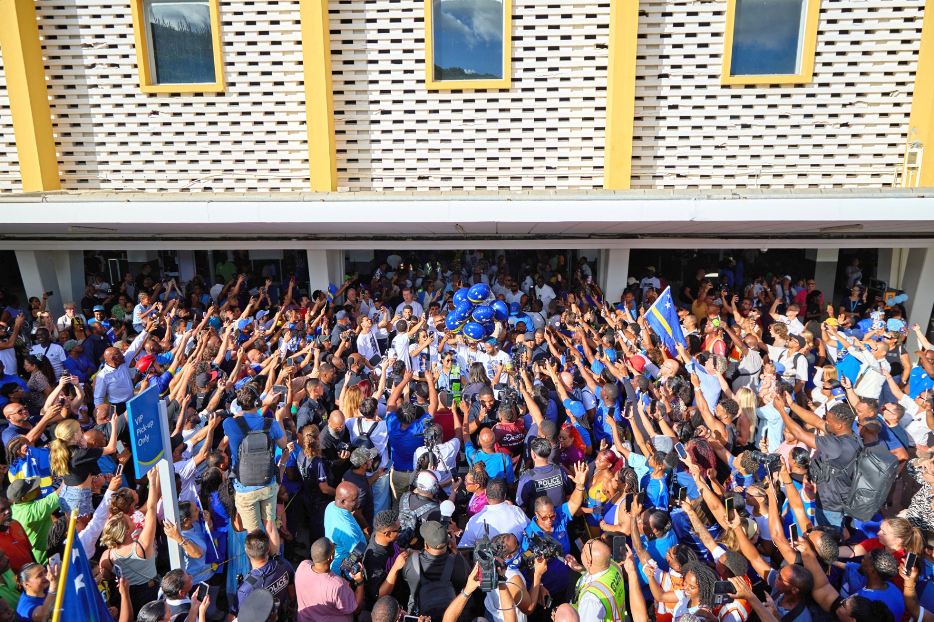 Welcome home — fans flood Hato airport to celebrate the squad.